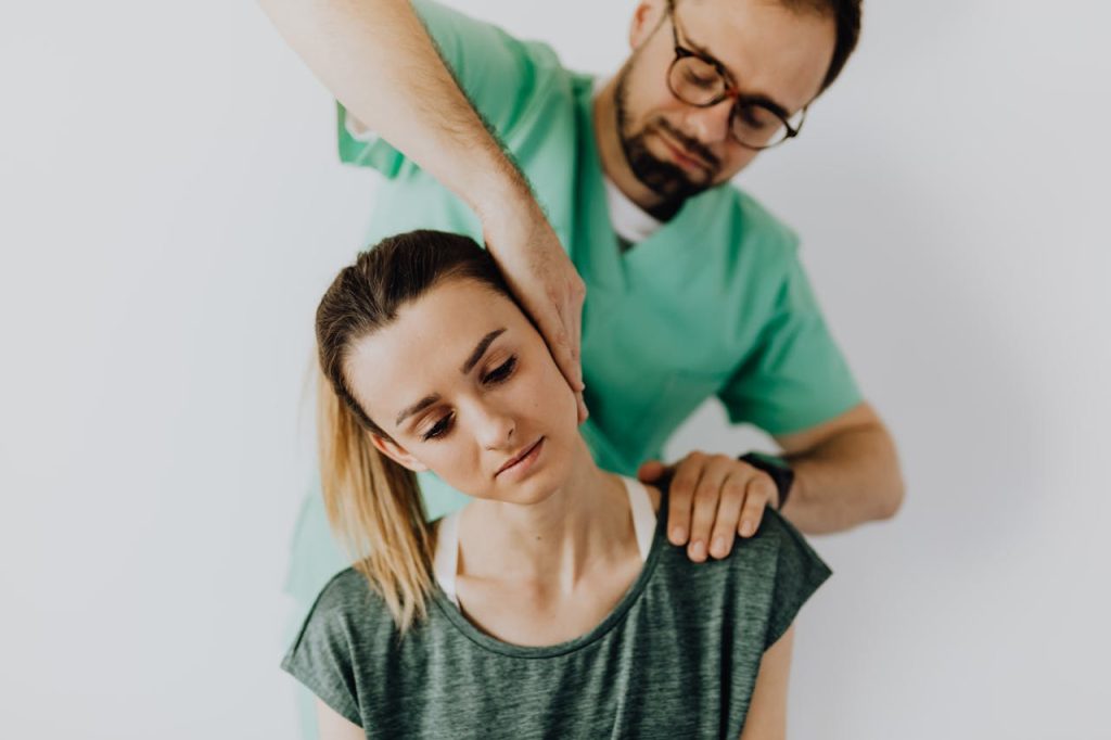 Professional chiropractor treating a womans neck pain with therapeutic techniques.